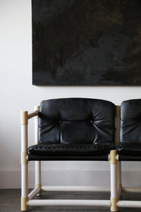 MCM mid-century modern  love seat with black vinyl upholstery in the style of Jerry Johnson for Landes Manufacturing Co.