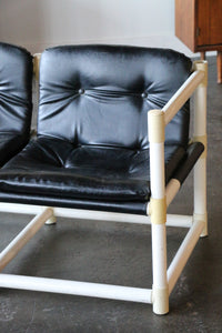 MCM mid-century modern  love seat with black vinyl upholstery in the style of Jerry Johnson for Landes Manufacturing Co.